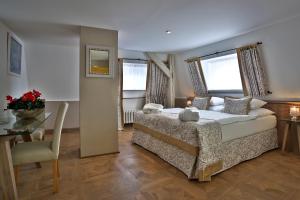a bedroom with a bed and a table and a chair at Belvedere in Prague +37 photos