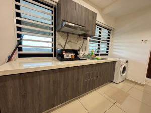 a kitchen with a counter top and a microwave at NEW-Serene Home Juru Sentral Icon City in Bukit Mertajam