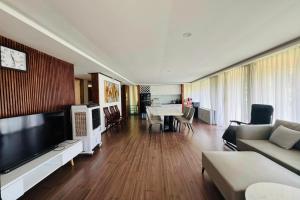 a living room with a couch and a dining room at BonBon Villa & Coffee in Bảo Lâm