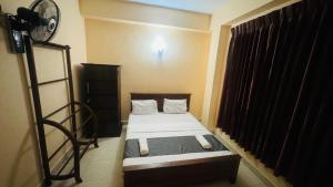 Postel nebo postele na pokoji v ubytování TASHINI Hotel