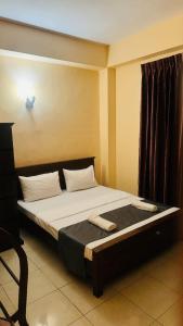 Postel nebo postele na pokoji v ubytování TASHINI Hotel