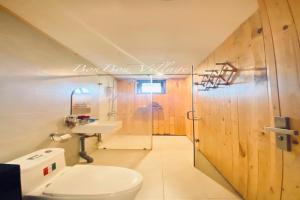 a bathroom with a toilet and a sink at BonBon Villa & Coffee in Bảo Lâm +77 photos