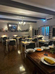 a dining room with tables and chairs in a restaurant at Hotel Boavista - Vintage House in Monfortinho