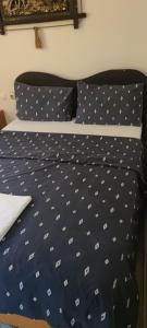 a bed with polka dot sheets and pillows at İmperial Hotel in Konak