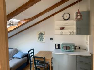 a kitchen and dining room with a table and a microwave at Alle scalette in Trieste