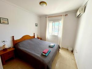 a bedroom with a bed with two towels on it at Monte Mar Apartment in Gran Alacant +11 photos