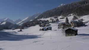a snow covered village on a snowy mountain at Cozy Apartment in Haut-Intyamon with Garden 75 m² in Albeuve +3 photos
