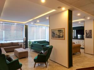a living room with couches and a couch and chairs at Akman City Hotel in Kusadası