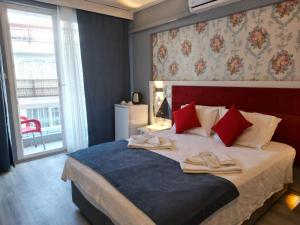 a bedroom with a bed with two slippers on it at Akman City Hotel in Kusadası +120 photos