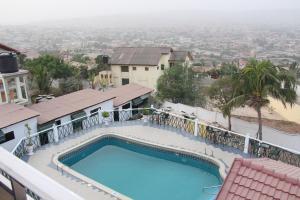 a swimming pool on the balcony of a house at Hill View Hotel McCarthy Hills in Botianaw