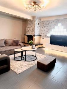a living room with a couch and a table at Geka's apartment in Skala Rachoniou
