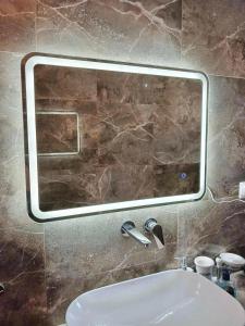 a mirror above a sink in a bathroom at Geka's apartment in Skala Rachoniou +21 photos