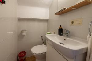 a white bathroom with a sink and a toilet at Bungalow Santa Pola I REF 059 in Santa Pola +15 photos