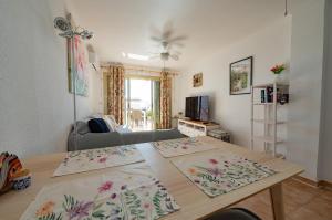 a living room with a table and a couch at Bungalow Santa Pola I REF 059 in Santa Pola