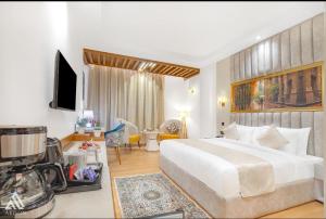 a bedroom with a large white bed and a living room at Arison Luxury in Srinagar