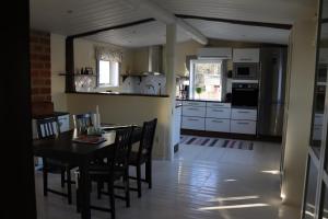 a kitchen and dining room with a table and chairs at Bäckens Guesthouse in Älgarås