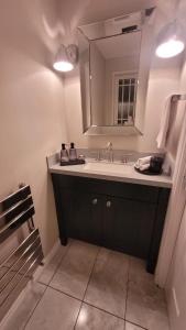 a bathroom with a sink and a mirror at 3 bedroom Sleeps 6 free parking in Glasgow +56 photos