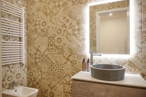 a bathroom with a sink and a mirror at Milan Retreats Porta Venezia Suites in Milan