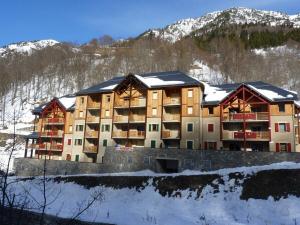 a large building in the snow with a mountain at Appartement Bois de Marie in Sers