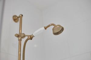 a shower head with a microphone in a bathroom at Skinningrove Apartment six in Skinningrove +44 photos