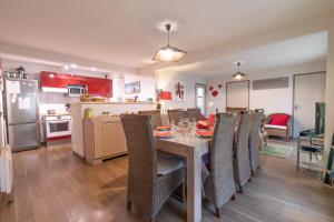 a kitchen and dining room with a table and chairs at Appartement Bois de Marie in Sers +24 photos