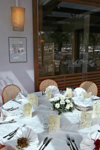a table in a restaurant with a white table cloth at Hotel Della Baia in Portovenere