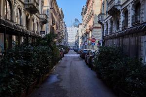 a narrow alley with parked cars on a city street at Milan Retreats Porta Venezia Suites in Milan