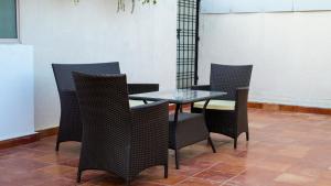 a glass table and chairs in a room at Luho Ever shine in Bangalore