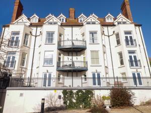 a large white building with a bridge in front of it at Apartment 7 Mansion House in Tenby