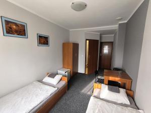 a small room with two beds and a desk at Moravia in Krzanowice