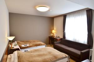 Kashihara Oak Hotel tesisinde bir odada yatak veya yataklar
