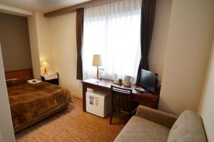 Kashihara Oak Hotel tesisinde bir odada yatak veya yataklar
