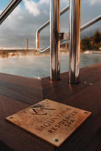a wooden sign sitting on top of a boat at The Mountains Hotel in Sierra Nevada