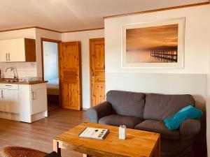 a living room with a couch and a table at Ferienwohnung im Ferienresort Kulkwitzer See Leipzig in Leipzig