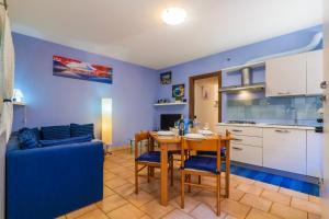 a kitchen and dining room with a table and a couch at Appartamento Gloria in Cannobio +38 photos