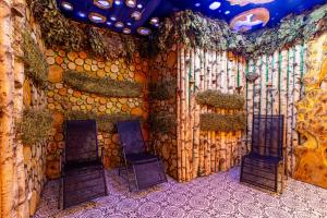 a room with three chairs and a wall of wood at Forest Home in Bukovel