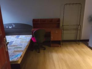 a small room with a desk and a bed and a desk at Navod Accomadation Service in Badulla