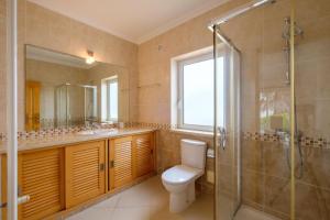 a bathroom with a toilet and a shower and a sink at Praia D'el Rey A1 - Golf & Beach in Óbidos +30 photos