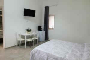 a bedroom with a bed and a table with chairs at B&B REVOLUTION BED e BREAKFAST in Caserta