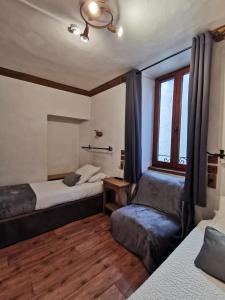a bedroom with two beds and a window at Hôtel Restaurant Angival - Chambres et Appartement in Bourg-Saint-Maurice +37 photos