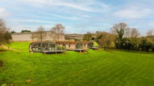 a green field with two domed buildings in it at Sustainable 2 Bedroom Pod on Old Chalford Farm! in Enstone