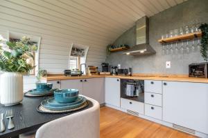 a kitchen with a table with blue dishes on it at Sustainable 2 Bedroom Pod on Old Chalford Farm! in Enstone