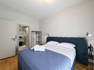 a bedroom with a blue bed with white pillows at Acropolis view 3BD penthouse next to tram and port in Piraeus