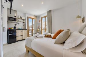 a white bedroom with a large white bed with pillows at MIMAR ALTEA ROOMS - Tranquil in Altea