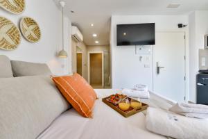 a white couch with an orange pillow and a box on it at MIMAR ALTEA ROOMS - Tranquil in Altea