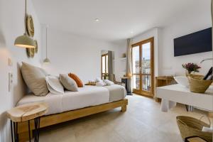a white room with a bed and a living room at MIMAR ALTEA ROOMS - Tranquil in Altea