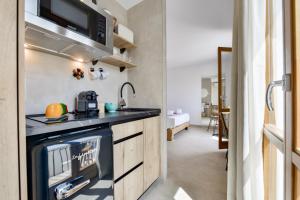 a kitchen with a stove and a sink in a room at MIMAR ALTEA ROOMS - Tranquil in Altea
