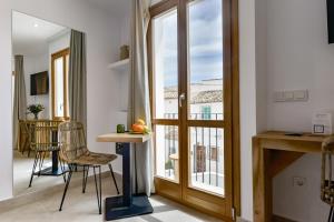 a room with a glass door with a table and chairs at MIMAR ALTEA ROOMS - Tranquil in Altea