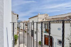 a row of white houses with a fence at MIMAR ALTEA ROOMS - Tranquil in Altea
