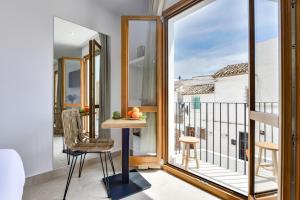 a room with a balcony with a table and a chair at MIMAR ALTEA ROOMS - Tranquil in Altea